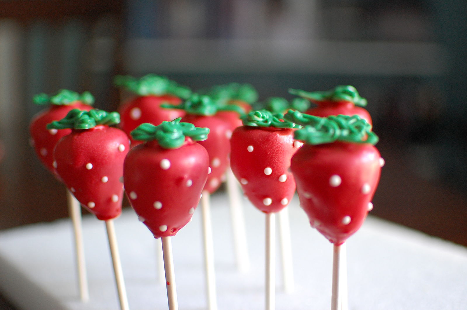 A few cake pops decorated as small strawberries!!